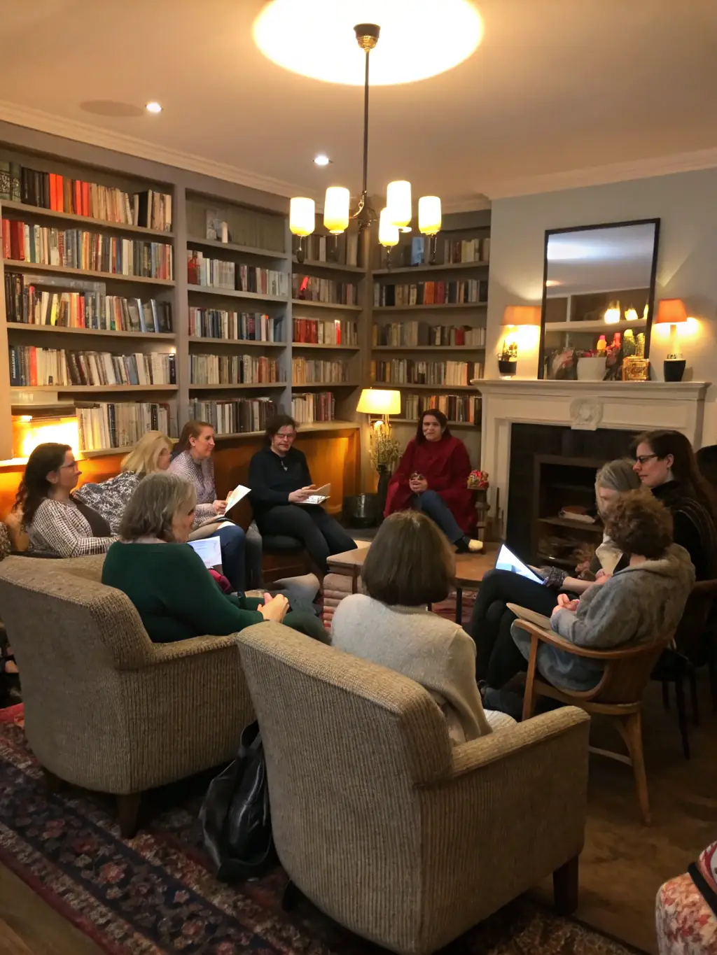 A group of people sitting around a table, engaged in a lively discussion during a book club meeting at GoGames.